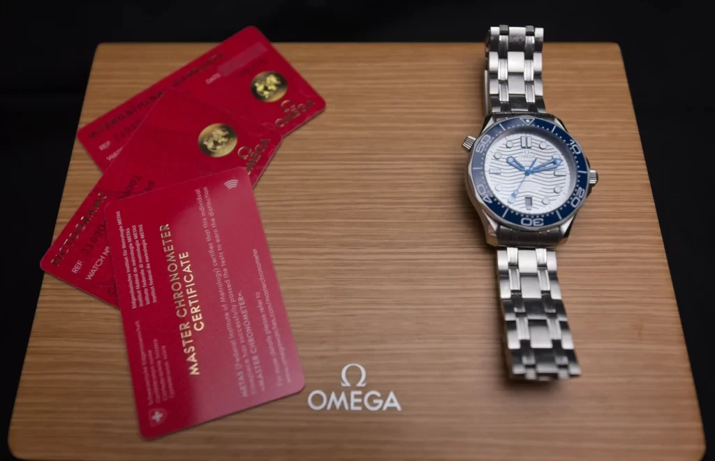 The watch on original box alongside certification cards
